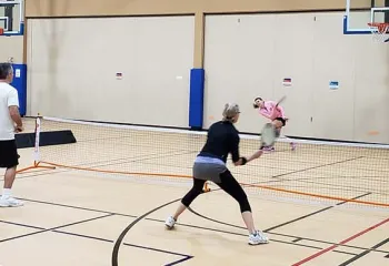 adults playing pickleball