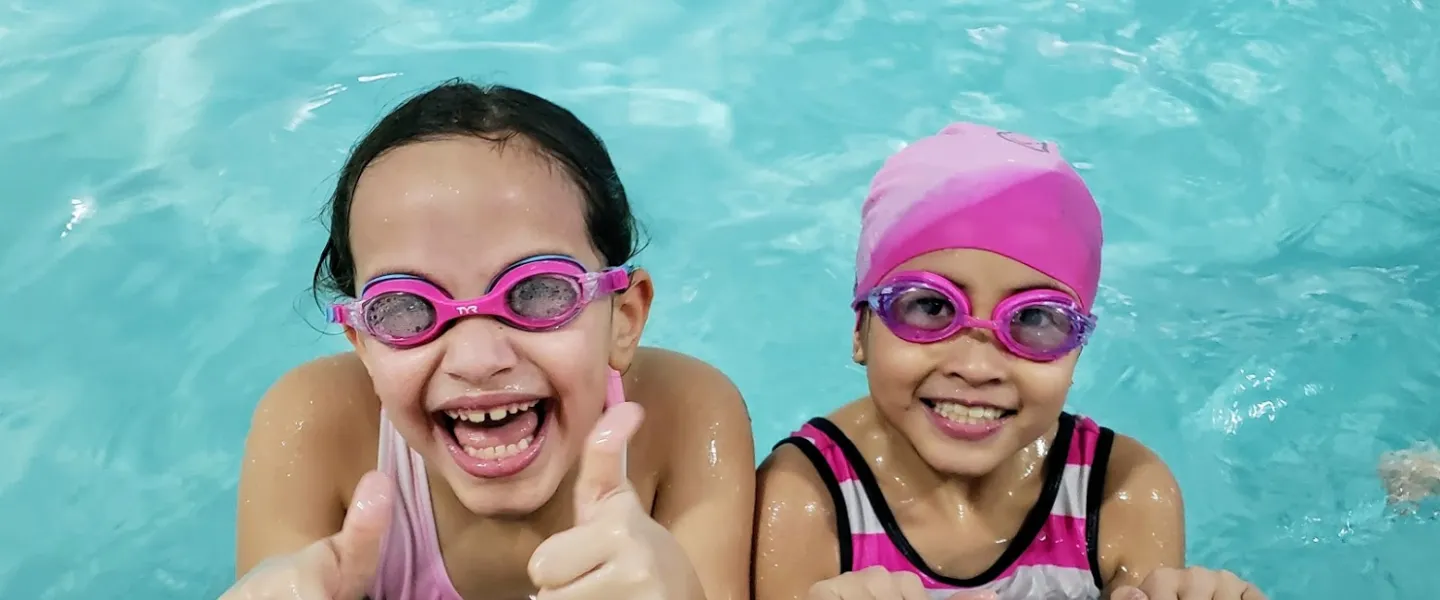 girls smiling in swimming pool