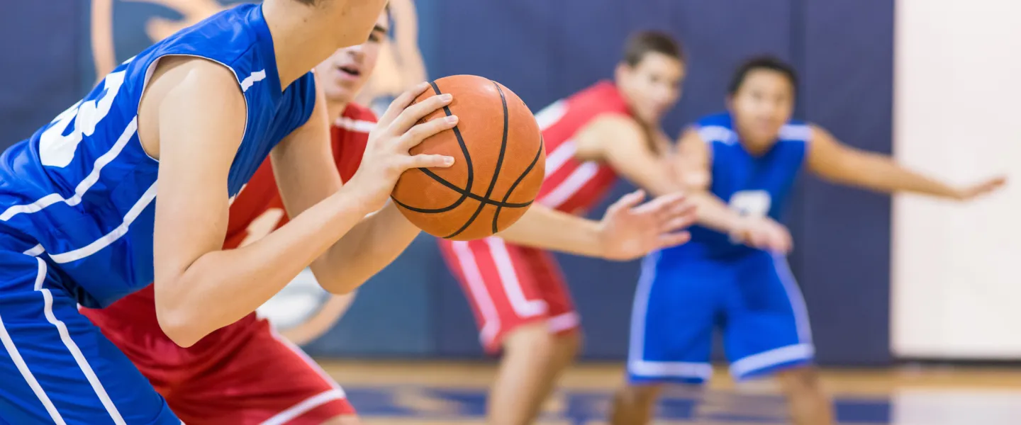 teen boys playing basketball