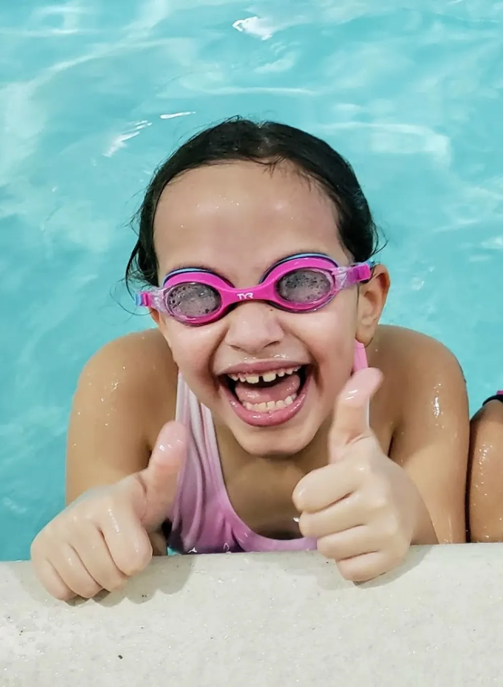girls smiling in swimming pool