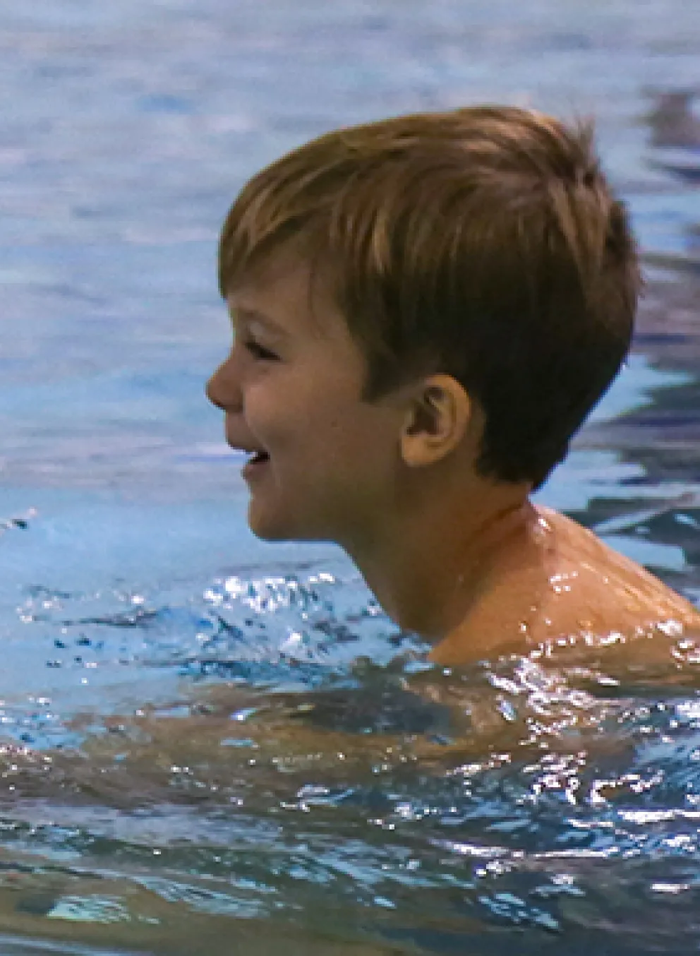 instructor in water with young child