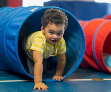 child crawling through tunnel