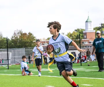 young teen playing flag football