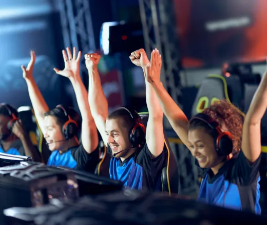 esports participants hands raised in victory