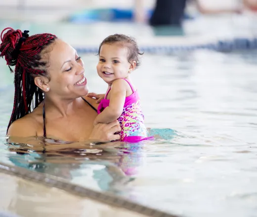mom in water with toddler daughter