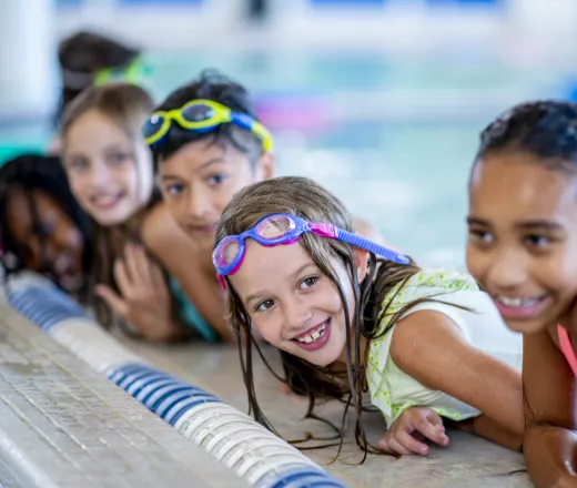 kids smiling in water swim lesson