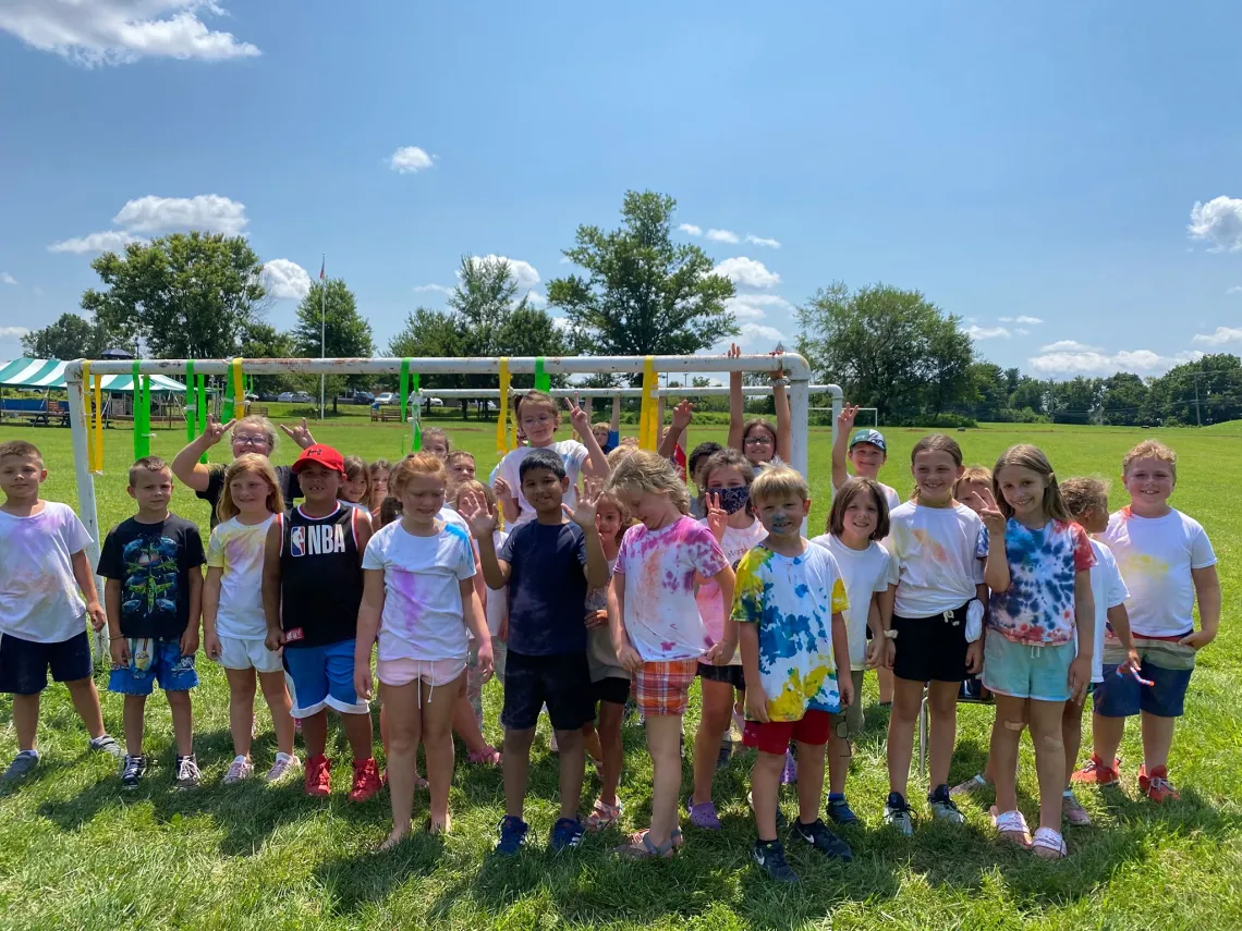 group of 30 children pose for outdoor photo